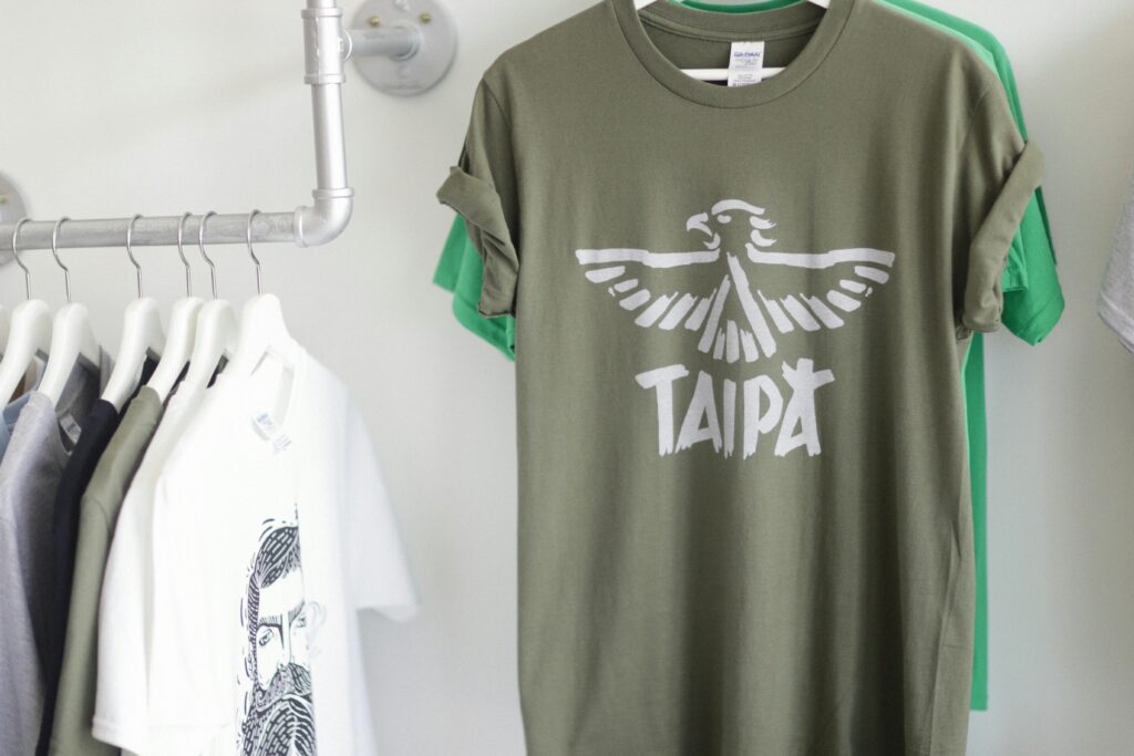 A row of fashionable T-shirts hanging stylishly in a bright retail space.